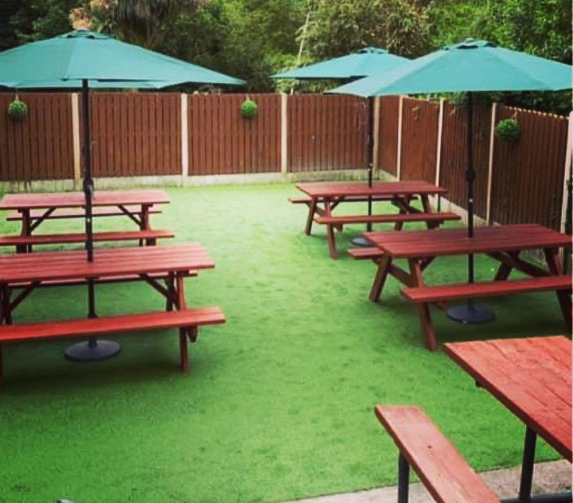 The Ring Lyne beer garden — picnic tables and umbrellas in the sun