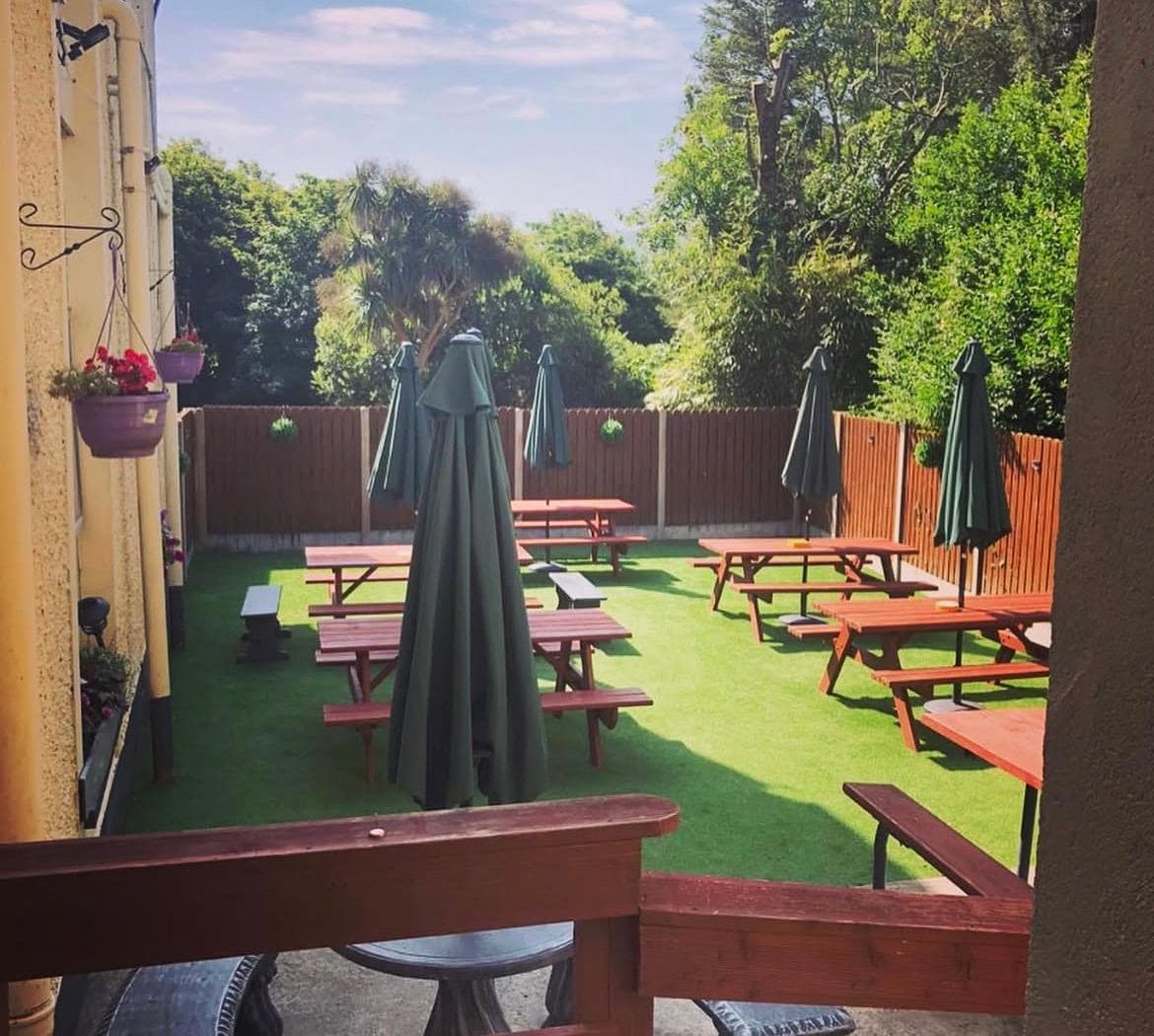 The Ring Lyne beer garden — picnic tables and umbrellas in the sun